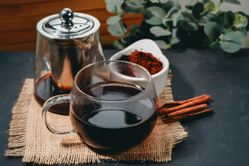 Black coffee and cinnamon sticks. Aromatic coffee from freshly ground coffee grounds.