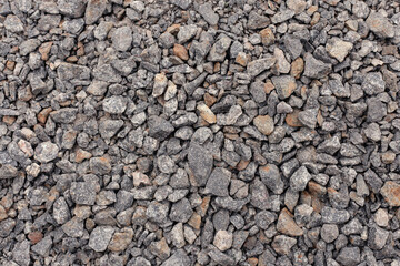 Crushed stone close up. Crushed stone construction materials. Small stones ground. Small stone construction material. Background, texture of stones. 