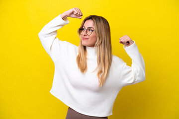 Young Uruguayan woman isolated on yellow background doing strong gesture