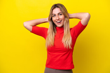 Young Uruguayan woman isolated on yellow background laughing