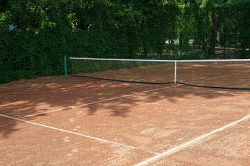 Clay tennis court outdoors. Grid and marking lines visible. Sport game, Leisure activity