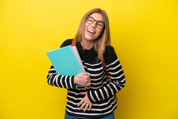 Young student woman isolated on yellow background background smiling a lot