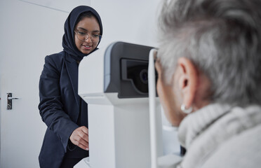 Optometrist, muslim woman and testing eyesight health in optometry lab with optical machine...