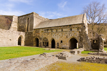 Fototapeta na wymiar The ruins of Valle Crucis Abbey viewed dining hall. Founded as a Cistercian monastery in 1201 and closed in 1537 it is a prominent landmark in the vale of Llangollen Wales
