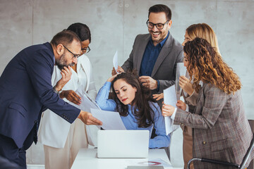 Group of business workers working together. Partners stressing one of them at the office. Depressed business woman. Female office worker is tired of work and exhausted. 