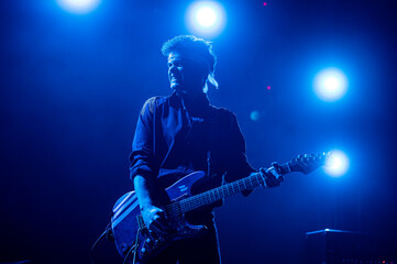 Obraz na płótnie Canvas Guitarist performing at a live concert.