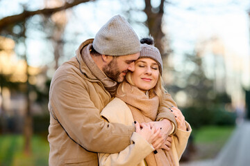 Fototapeta premium Embraced mid adult couple in the park