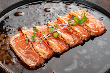 Fresh salmon fillet cut into pieces on a plate with soy sauce. Asian dish sashimi from raw salmon - Powered by Adobe