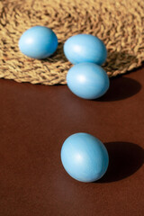 Easter blue eggs on a brown background.