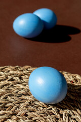 Easter blue eggs on a brown background.