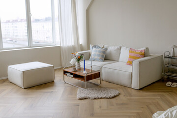 White sofa and coffee table in a bright room. Nice parquet floor.