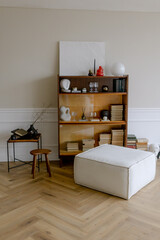 Stylish and vintage bookcase with shelves for books. Interior minimalism and light colors