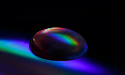 Macro photo of an opal gemstone on a colourful background 