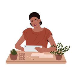 An accountant works in finance. Young smiling African American woman holding a tablet PC, paper. A beautiful business lady is working at the office desk.