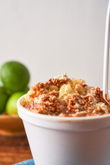 Mexican snack, prepared esquite, corn in a cup, with chili