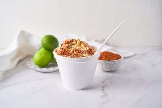 Esquite, mexican corn salad with chili and cheese, street food from mexico.