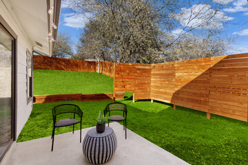 Back patio with a wood fence