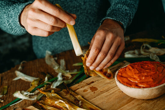peeling off a calcot typical of Catalonia, Spain