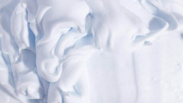 Blue mousse foam creamy texture. Cosmetic cleanser, soap, cream, shampoo sample. Foamy skincare product smear smudge. Stop motion animation.