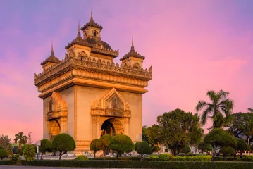 Fotobehang Beautiful sky sunset of Landmark The Ancient Patuxai or Patuxay is a war monument in the centre of Vientiane, Laos © Piyanat