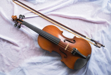 Fototapeta na wymiar Violin put on background,show detail of acoustic instrument