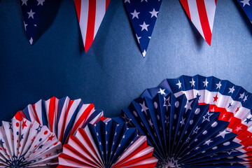 Happy Labor Day, Presidents Day, Fourth of July Independent Day, Memorial day, Columbus day background. Dark blue background with USA flag color paper fans and decorations, party accessories