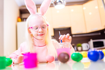 Cute little child blond girl wearing bunny ears on Easter day