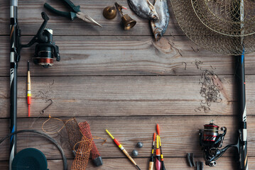 Fishing tackle background. Lifestyle. Spinning, hooks. Accessories for fishing on the wooden...