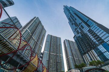 Fototapeta premium Beautiful evening at landmark 81, the tallest building in Vietnam. The building lights up with colorful lights in the evening. Travel concept