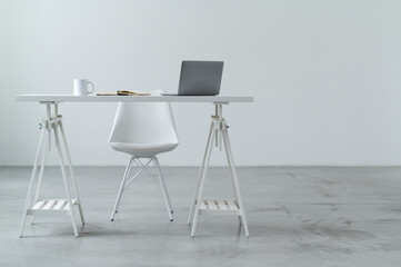 Work area with table and chair. A laptop notebook and headphones are on the table. Isolated on white background.