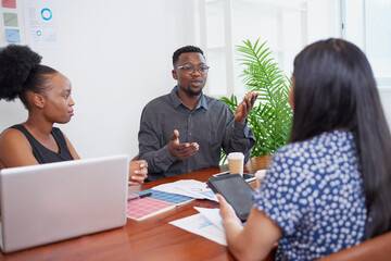 Team of diverse colleagues have heated discussion debate, boardroom table brainstorm