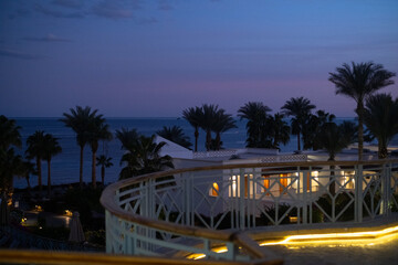 Palm trees against white home by the beach with blue sky and sand The top of the house or apartment with nice window