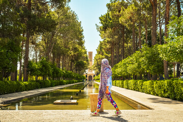 Female tourist visit famous sightseeing attraction in Dowlat Abad Garden , Yazd , Iran