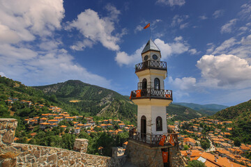 Fototapeta na wymiar The Victory Tower (Zafer Kulesi) with the traditional houses in the background. Goynuk, Bolu, Turkey. Shooting with drone