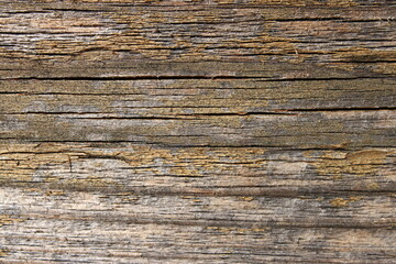 a weathered wooden board with horizontal cracks