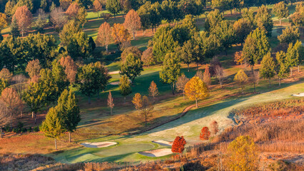 Golf Course Green Traps Trees Overlooking Landscape in Mountain Terrain.