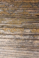 a weathered wooden board with horizontal cracks