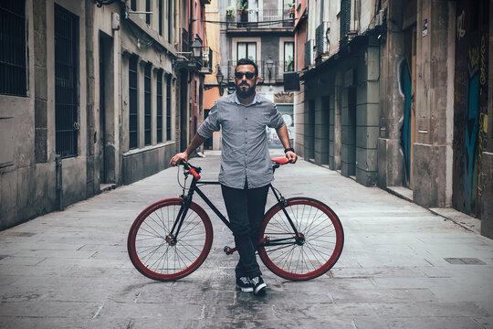 Bearded guy with bicycle in town