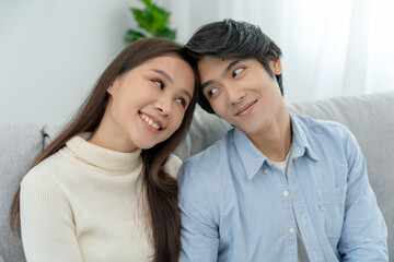 Asian couple smile and happy looking each other's eyes, cuddling, warm hugs, teenager's first love, married couple, warm family. Husband and wife in love so fun in new years eve or valentine day