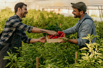 Two male planters working together, exchanging goods and homegrown products.