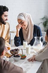 positive muslim family having breakfast during ramadan at home.