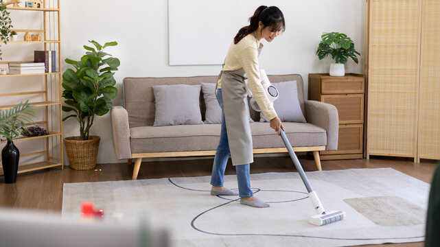 Beautiful Woman Vacuuming The Floor And Carpet In Her Living Room, Big Cleaning In The House, Removes Germs, Housewife Cleaning, Keeping Her Home Clean, Domestic Hygiene.