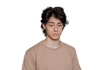 Upset handsome schoolboy tired looks down standing against transparent background. Unhappy guy with dark hair frustrated, depressed. Exhausted Spanish student feels fatigue. Sad people.