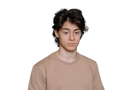 Upset handsome schoolboy tired looks down standing against transparent background. Unhappy guy with dark hair frustrated, depressed. Exhausted Spanish student feels fatigue. Sad people.