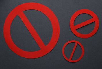 Red prohibition signs on dark gray background