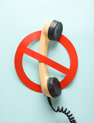 Telephone receiver with a prohibition sign on a blue background - obrazy, fototapety, plakaty