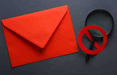 Envelope and Magnifying glass with prohibition sign on dark background