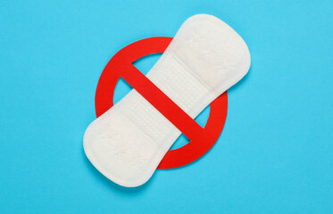 Menstruation pad with prohibition sign on blue background