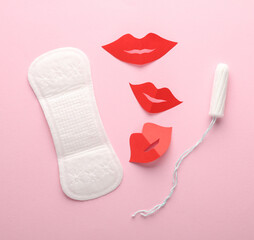 Menstrual pad with tampon, hearts and lips on pink background. Flat lay