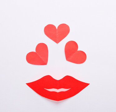 Paper red lips with hearts on a white background. Falling in love concept